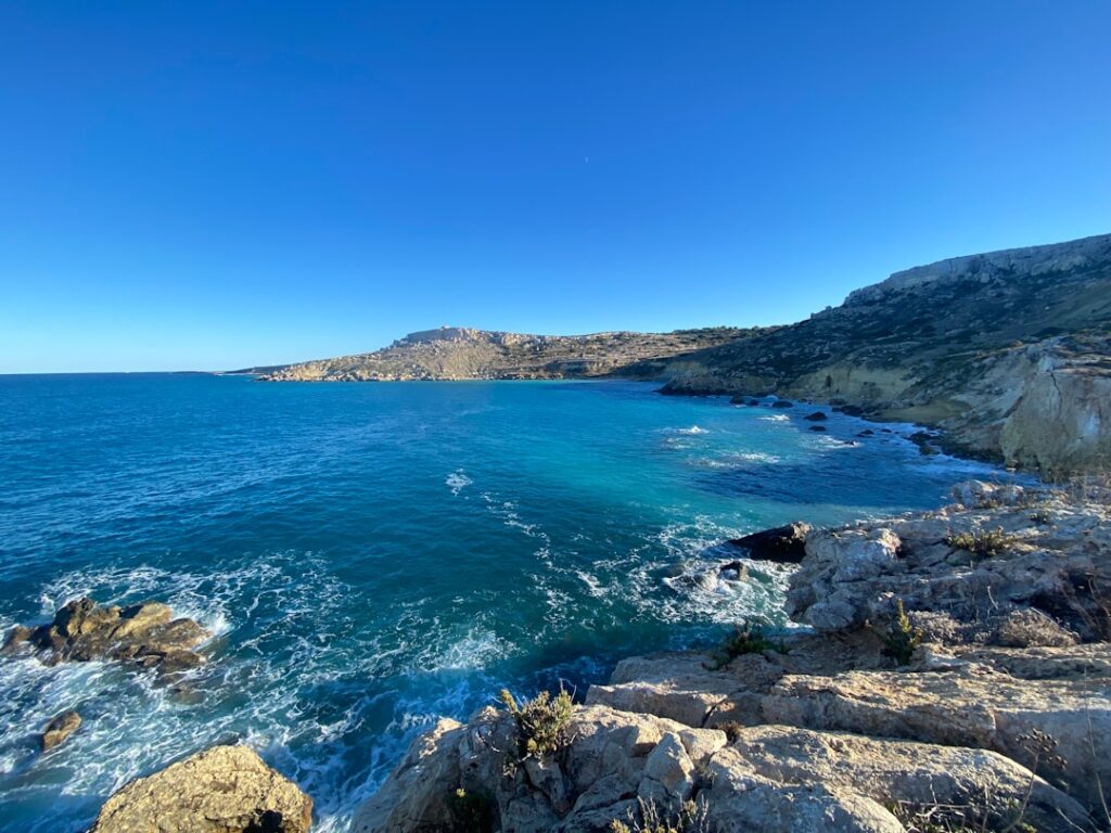 a body of water surrounded by rocky coastline