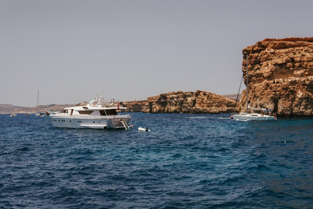A couple of boats floating on top of a body of water